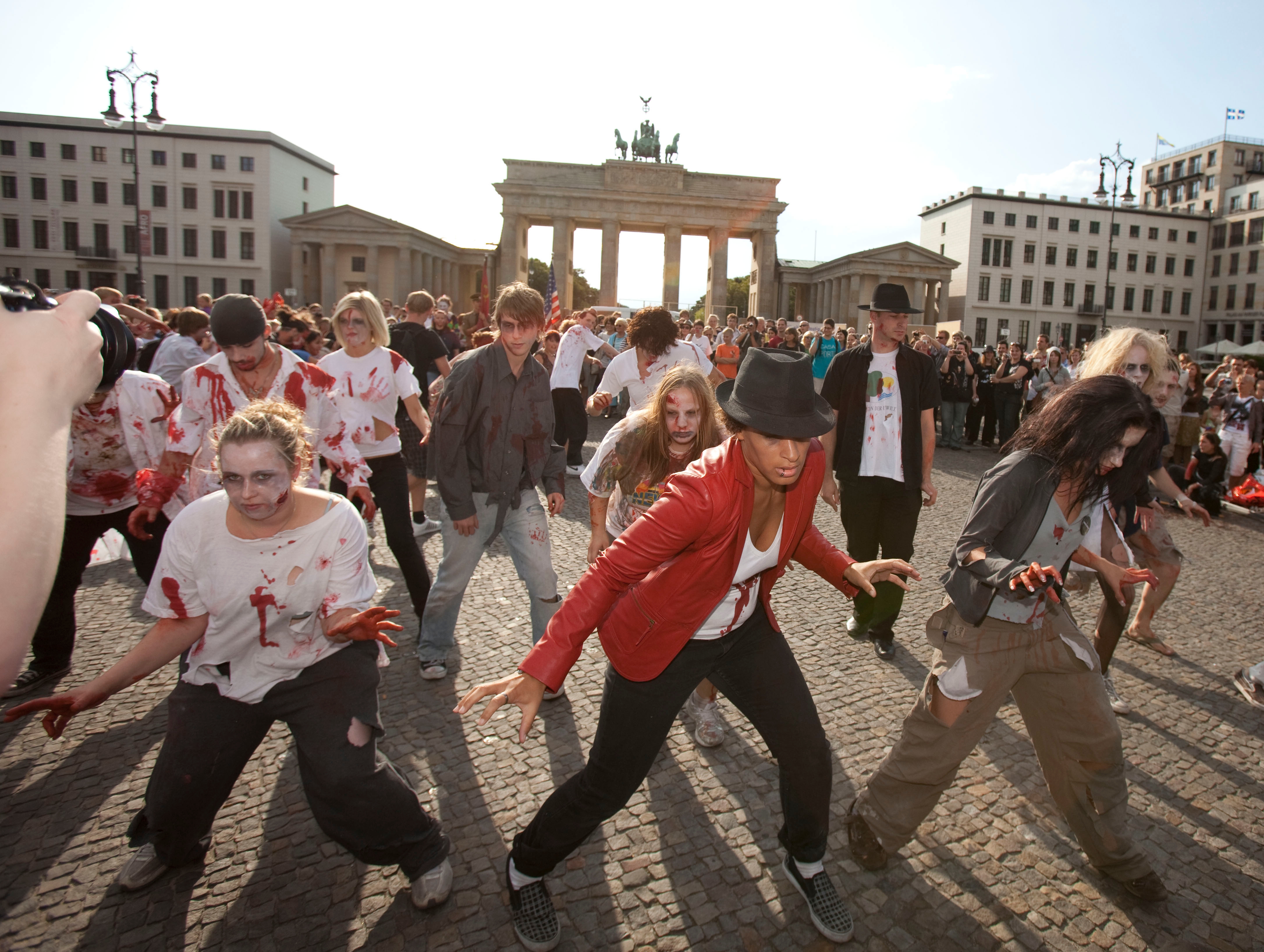 People successful  zombie costumes execute  a creation   successful  beforehand   of a humanities  landmark, resembling a nationalist   flash mob event