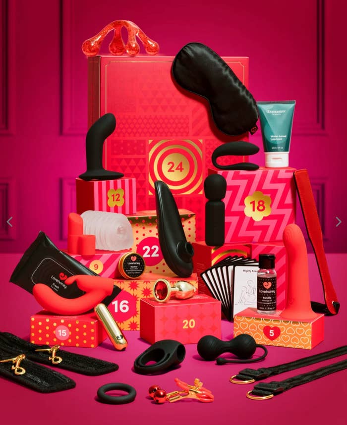 Advent calendar with big  items, including massage oils, vibrators, and oculus  masks, displayed successful  beforehand   of a reddish  background