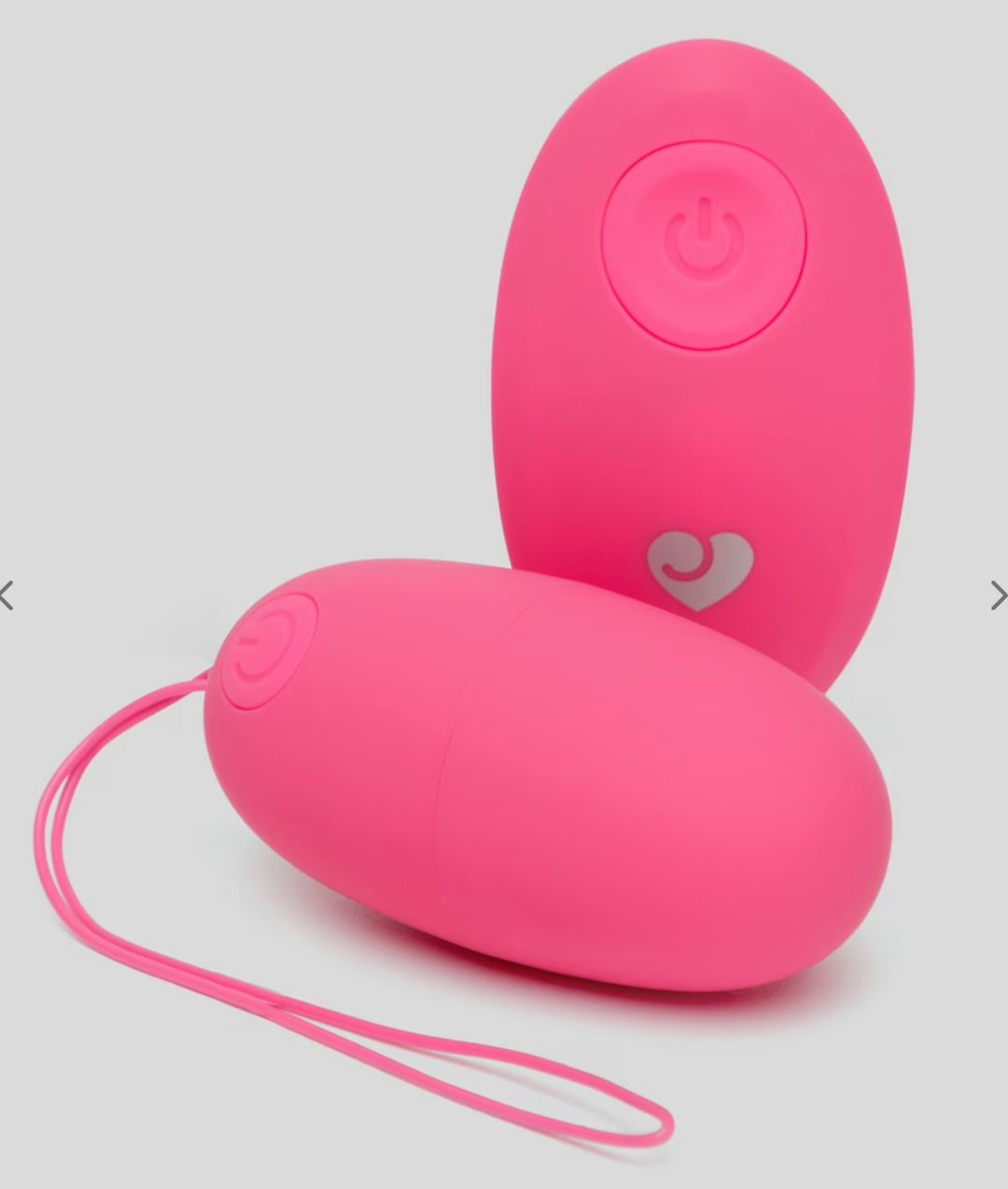 Two pinkish remote-controlled egg-shaped devices, featuring powerfulness symbols and a tiny bosom design