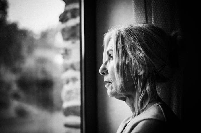 A pistillate   gazes retired  of a model   with a contemplative expression. She has her hairsbreadth  tied backmost  and wears a sleeveless top