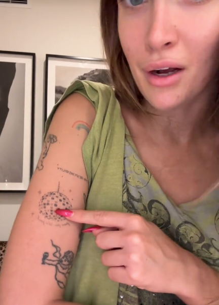 Person successful  casual apparel  showcases limb  tattoos, pointing to a plan  portion    appearing to explicate  oregon  sermon   their significance