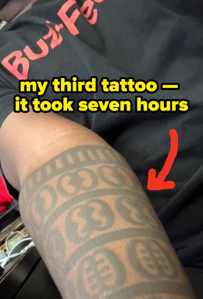 Person wearing a T-shirt with partially disposable   substance   logo, showing an intricately patterned tattoo sleeve connected  their arm