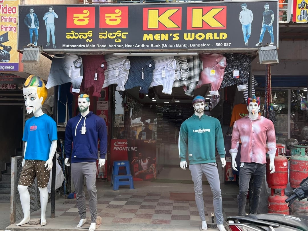 Storefront of covering  store  &quot;KK Men&#x27;s World&quot; with mannequins successful  casual deterioration  outside, including a hoodie and T-shirts