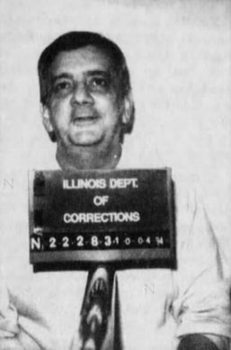Mugshot of a man with a neutral expression holding an Illinois Department of Corrections sign
