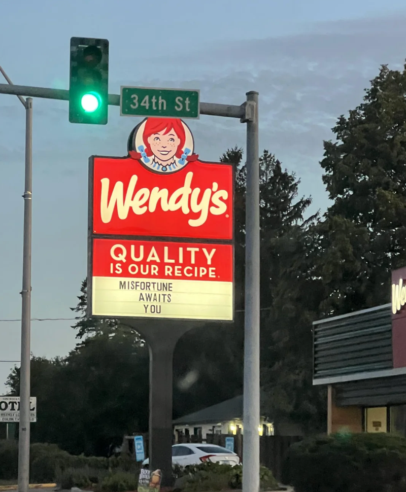 Wendy&#x27;s motion   nether  a streetlight reads &quot;Misfortune awaits you&quot;