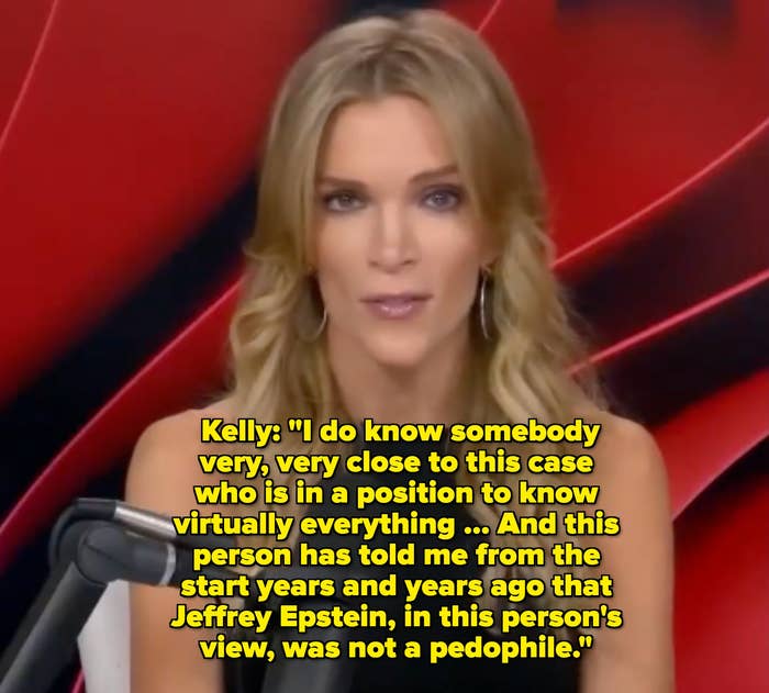 Person with long hair speaks into a microphone during a broadcast, seated against a dynamic abstract backdrop