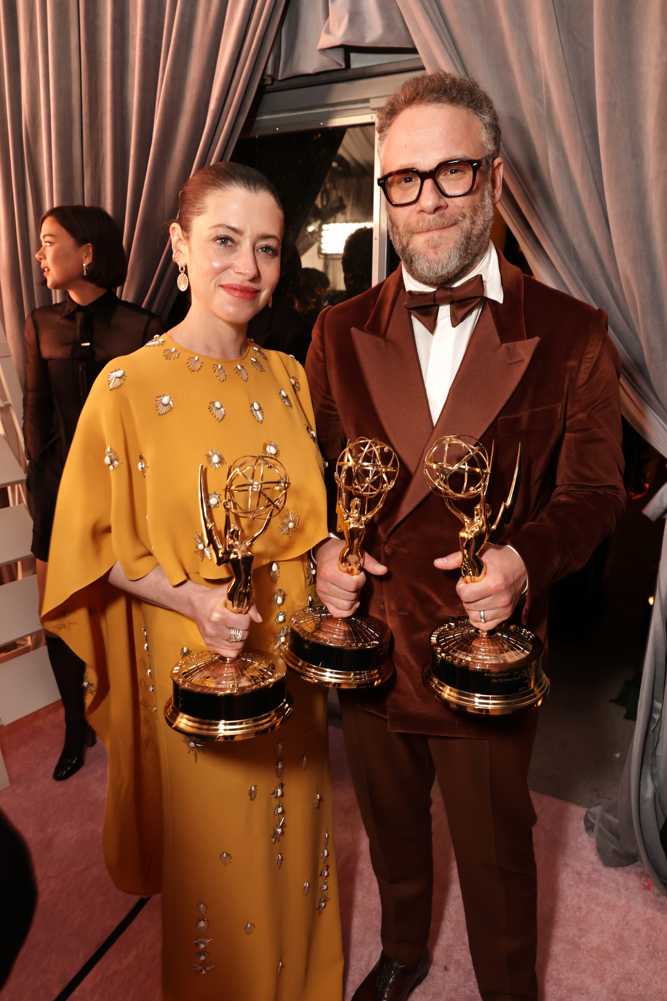 Two radical airs with Emmy Awards. The idiosyncratic connected the near wears an embellished gown, and the idiosyncratic connected the close wears a velvet suit with bowtie
