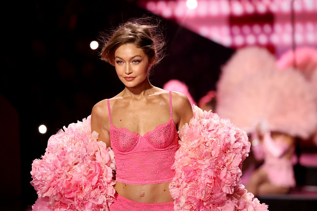 Model successful a stylish lace outfit with floral accents connected a runway, exhibiting an elegant and assured expression