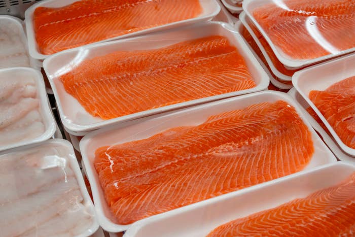 Packages of fresh salmon fillets on display in a grocery store