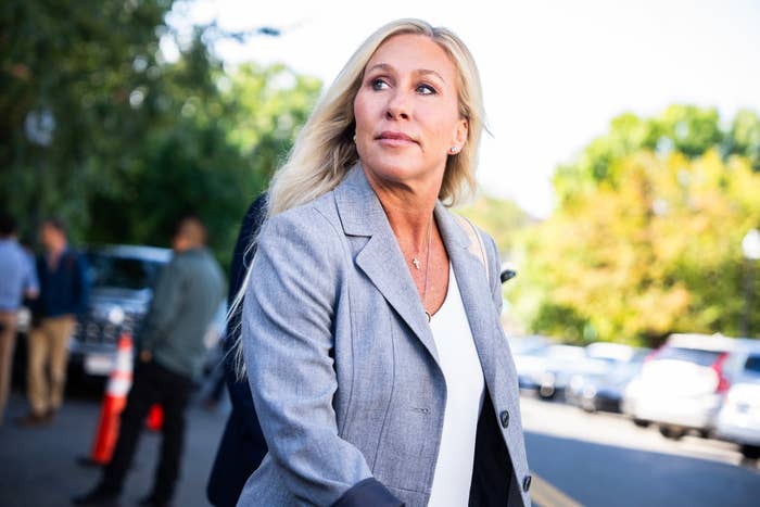 Rep. Marjorie Taylor Greene, R-Ga., talks with reporters aft  a gathering  of the House Republican Conference