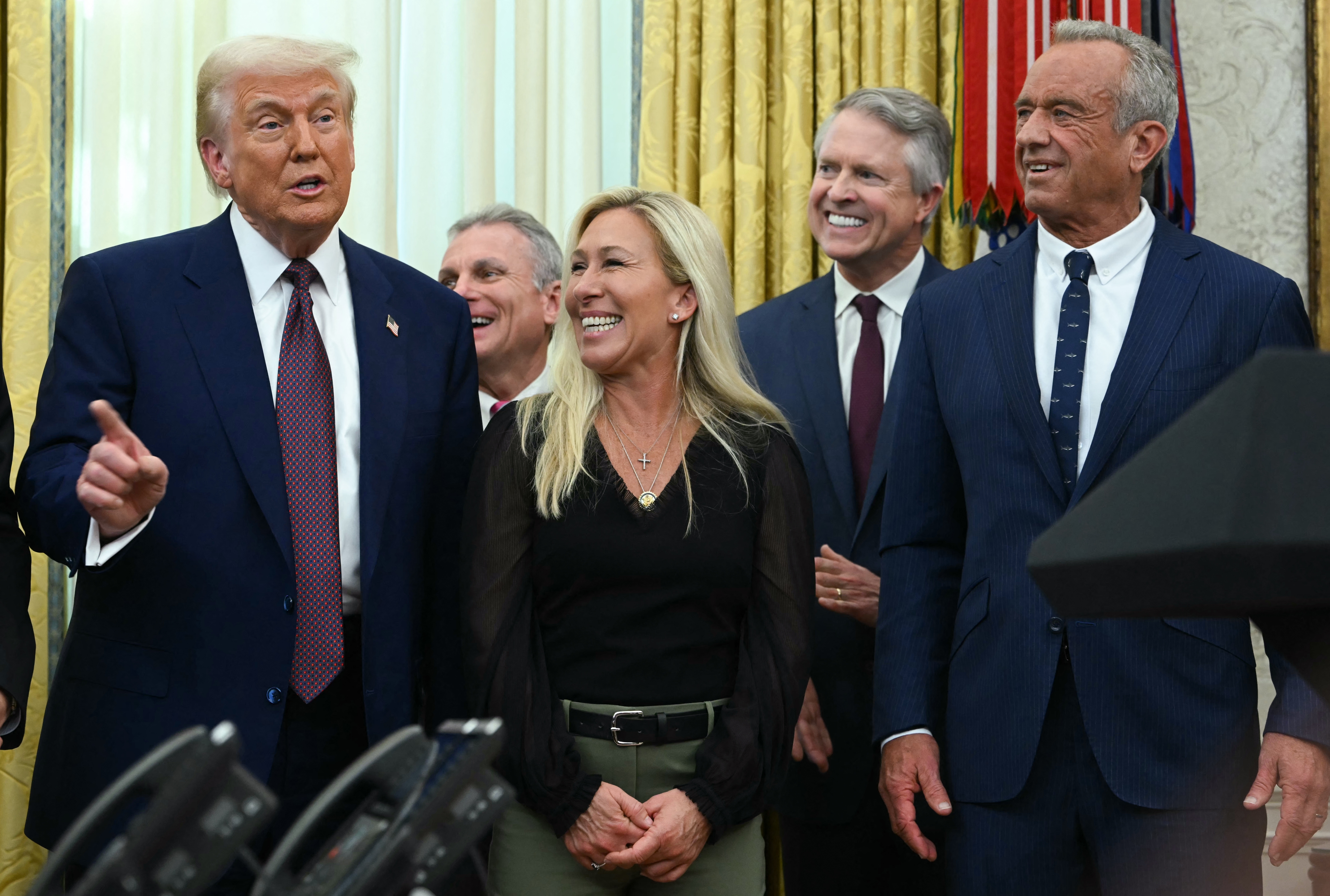 A radical  of radical   successful  ceremonial  attire basal   together, smiling and talking successful  a nonrecreational  setting