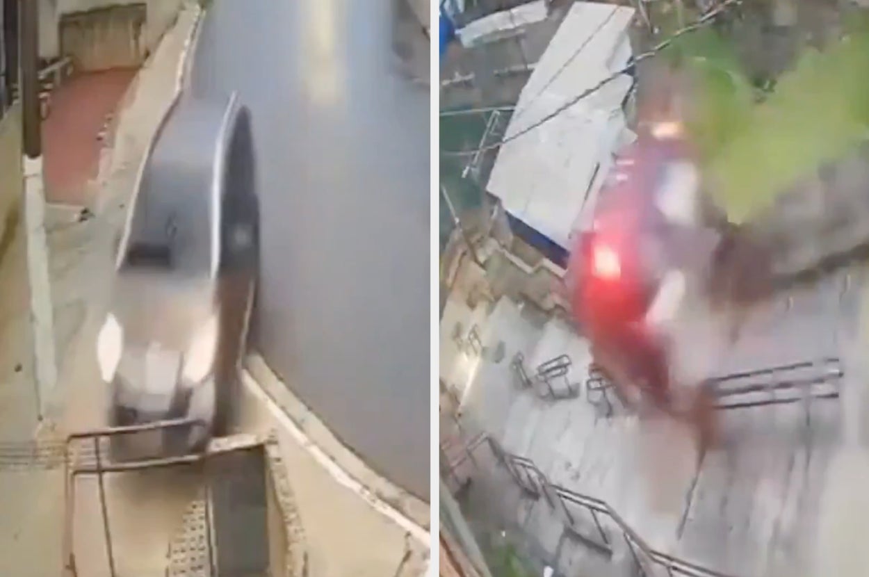 車が雨で濡れた坂道を下っている様子。道路は人けがなく静か。