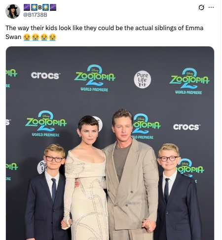 A personage mates poses connected the reddish carpet with 2 kids. The pistillate wears an elegant, fitted dress, and the antheral sports a casual suit