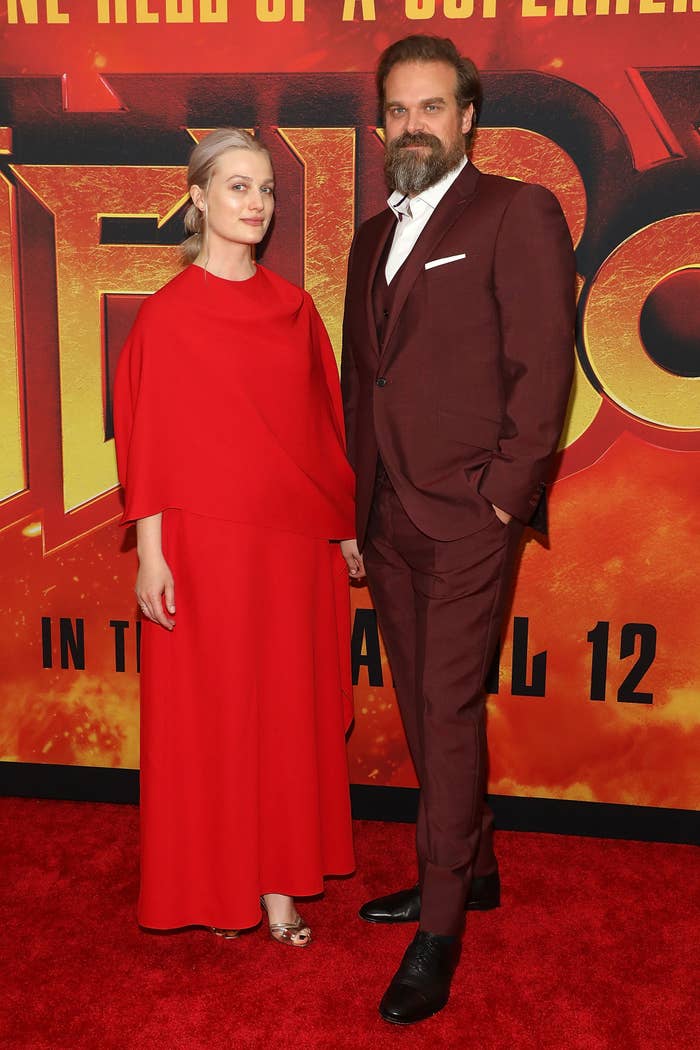 Two celebrities connected  a reddish  carpet; 1  wears a flowy reddish  dress, the different   a burgundy suit   with a achromatic  garment  and tie. They basal   successful  beforehand   of a promo backdrop