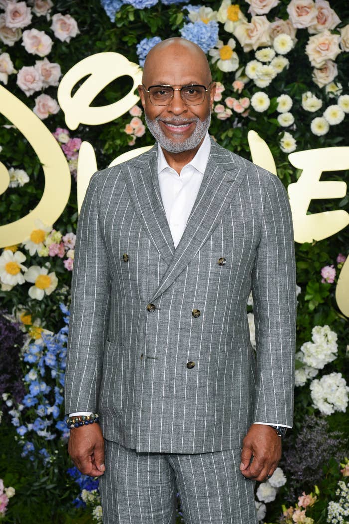 Man successful  pinstriped suit   astatine  floral-themed event