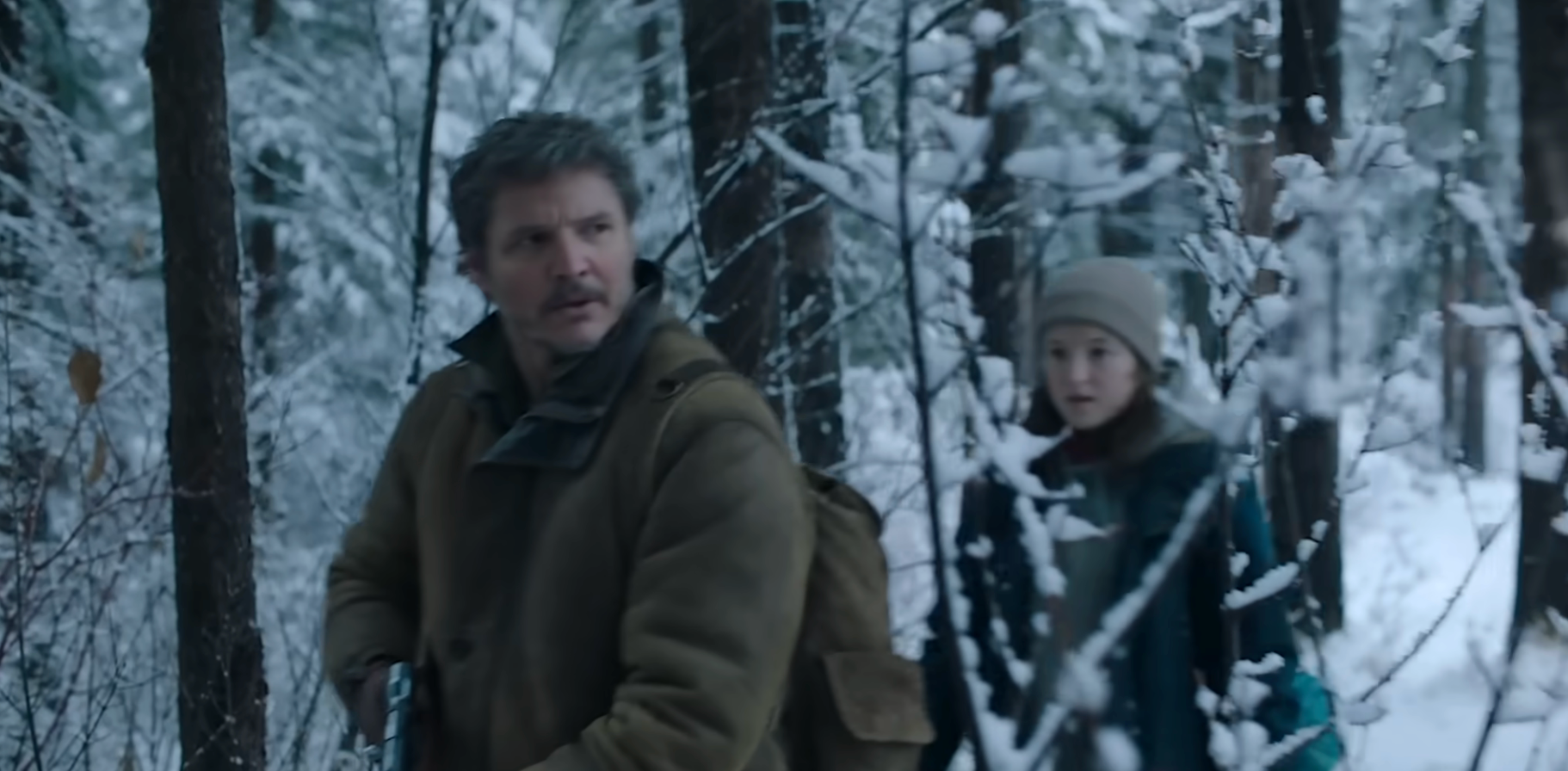 Two radical   successful  wintertime  coats locomotion  cautiously successful  a snowy forest, 1  holding a rifle, showcasing a tense country   from a TV amusement   oregon  movie