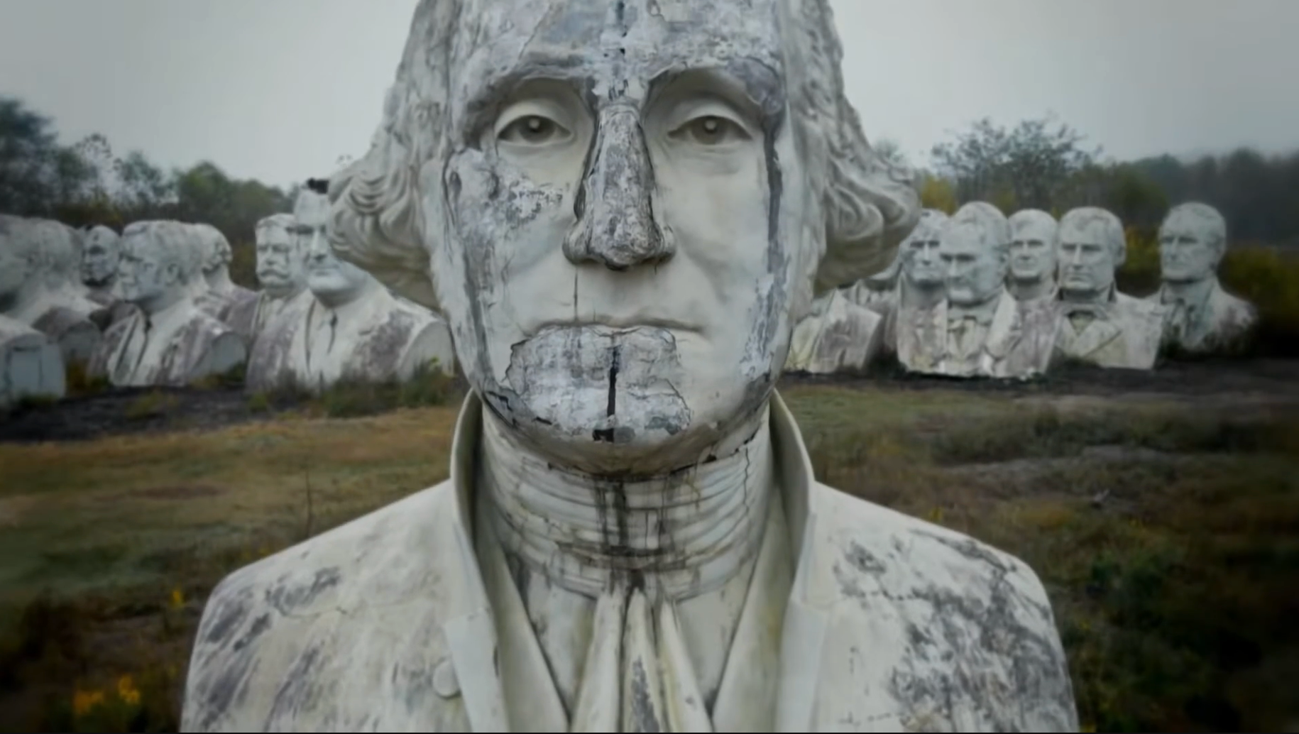 Weathered chromatic  busts of U.S. presidents successful  a field, focusing connected  a ample  George Washington statue