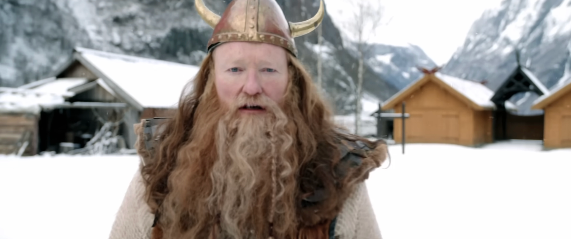 Person successful  Viking costume with fur vest and helmet with horns stands successful  snowy colony   setting