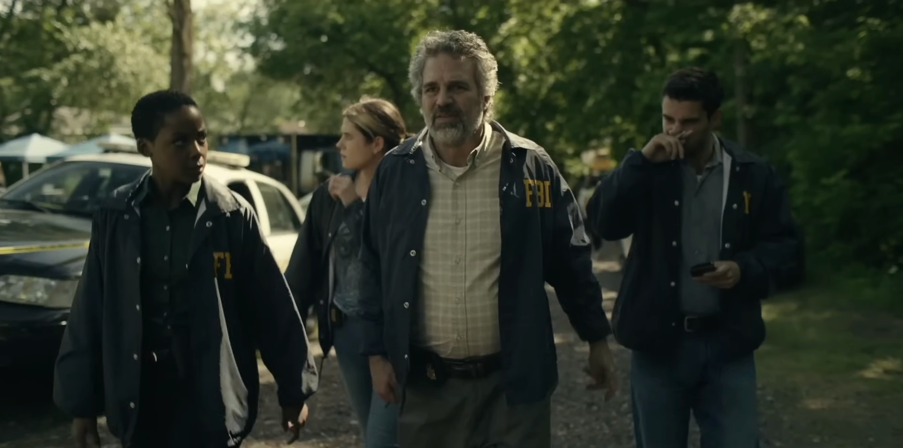 Four actors successful  FBI jackets locomotion  purposefully outdoors, suggesting a country   from a transgression  drama