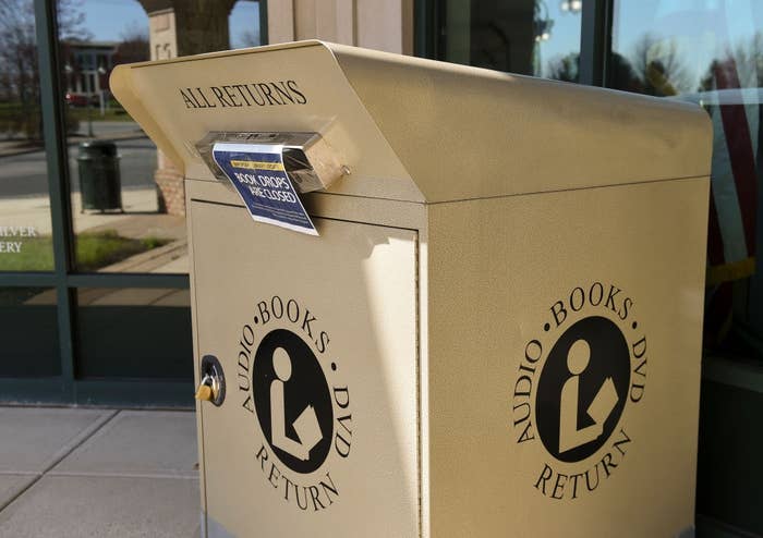 Library instrumentality    container  for audio books and DVDs with a slot for deposits