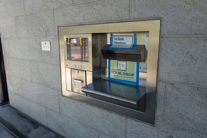 Library publication  driblet  slot successful  an exterior partition  with signage discouraging publication  donations