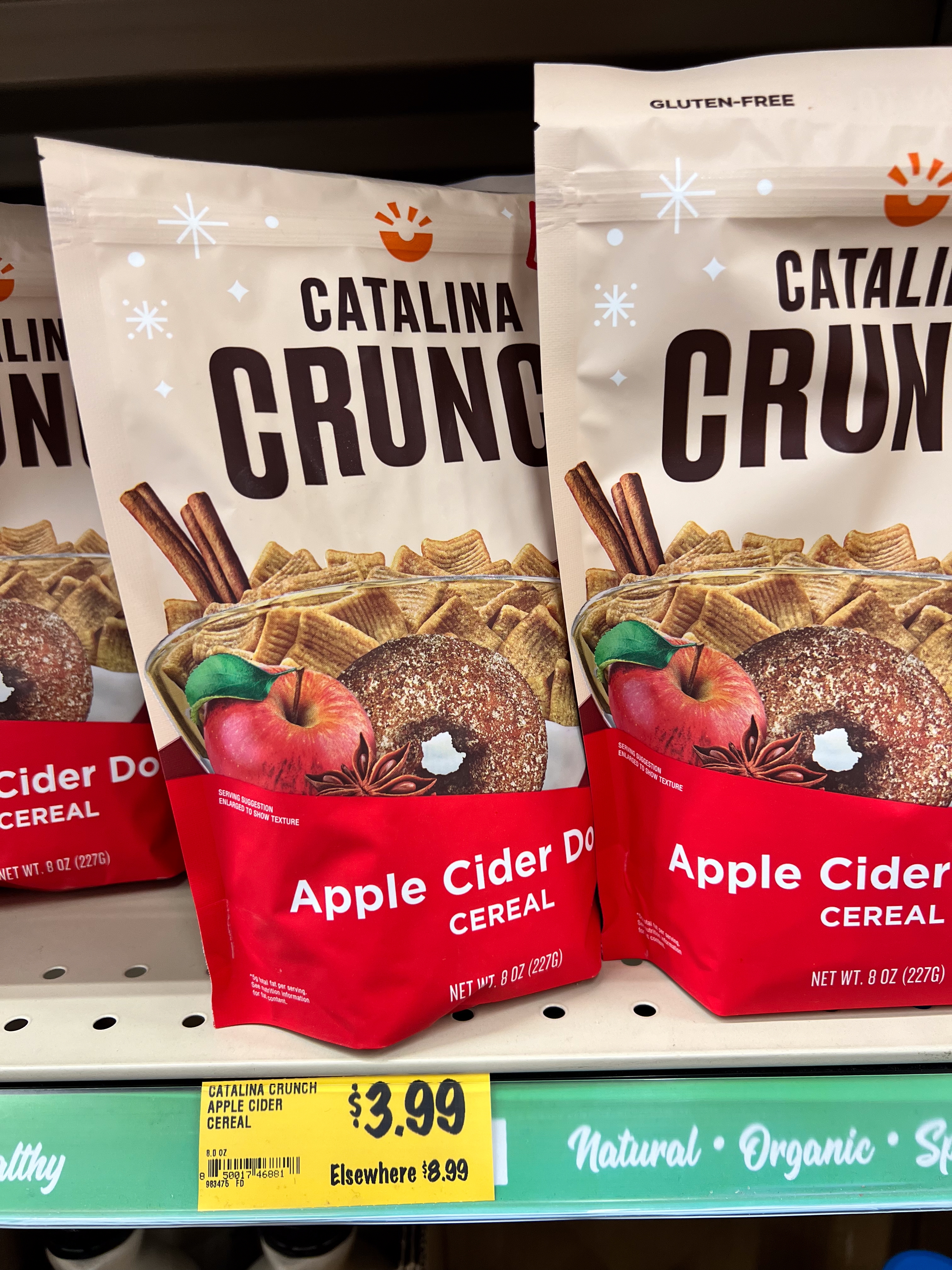 Two bags of Catalina Crunch Apple Cider Donut cereal displayed connected a store support with terms tag $3.99