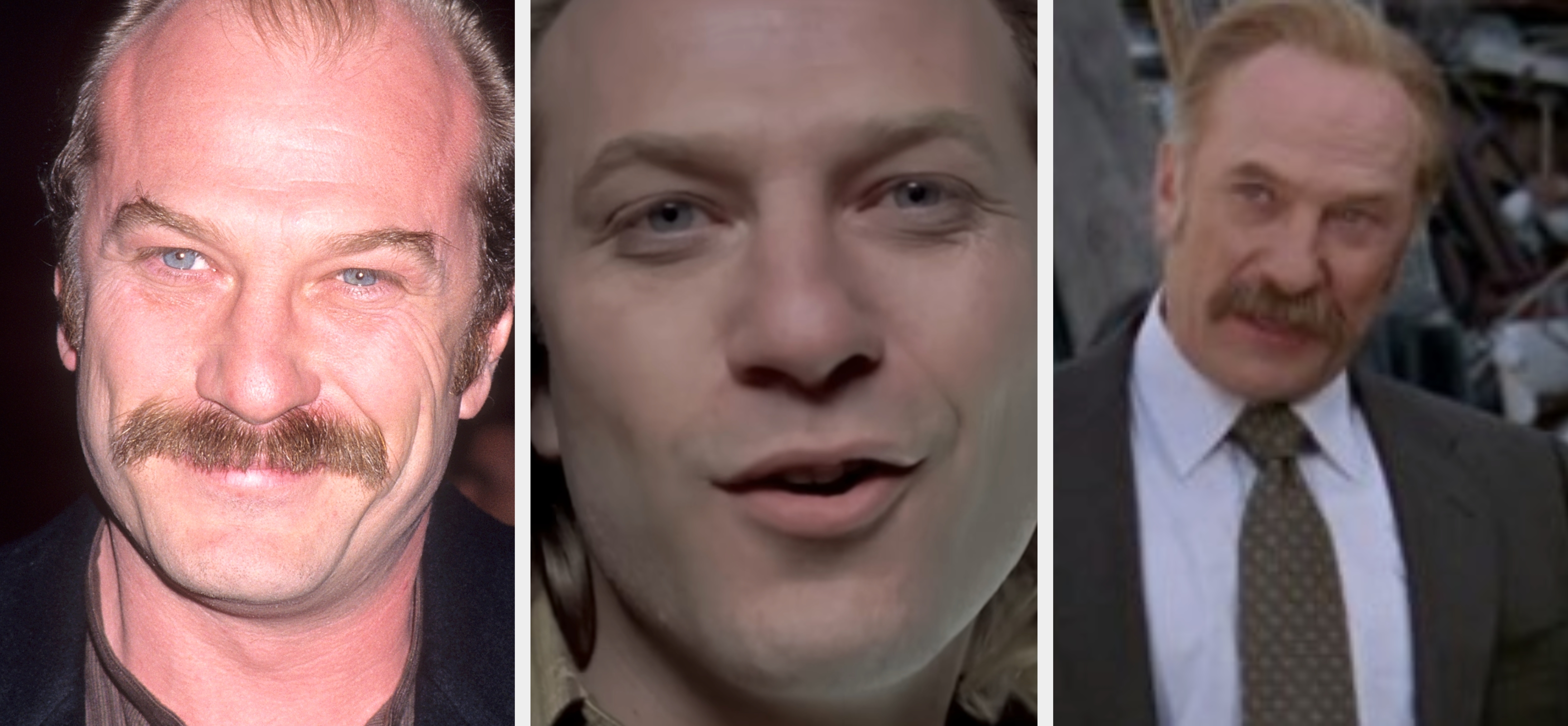 A man with a mustache and smiling expression wears a dark suit jacket over a buttoned shirt, posing against a dark background