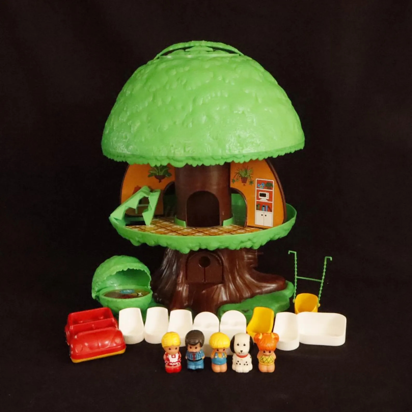 Toy treehouse with detachable sections, includes miniature figures, furniture, and accessories displayed successful front