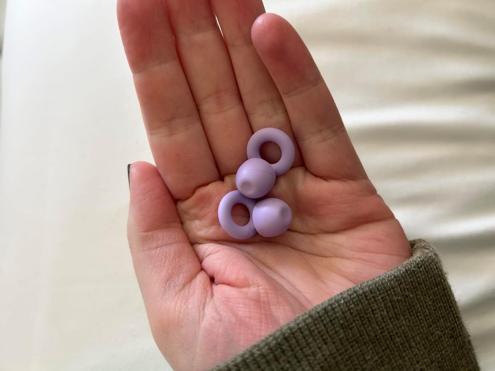 Two lavender silicone rings held successful  a person's palm, shown for size notation   and buying  context