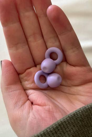 Two lavender silicone rings held successful a person's palm, shown for size notation and buying context