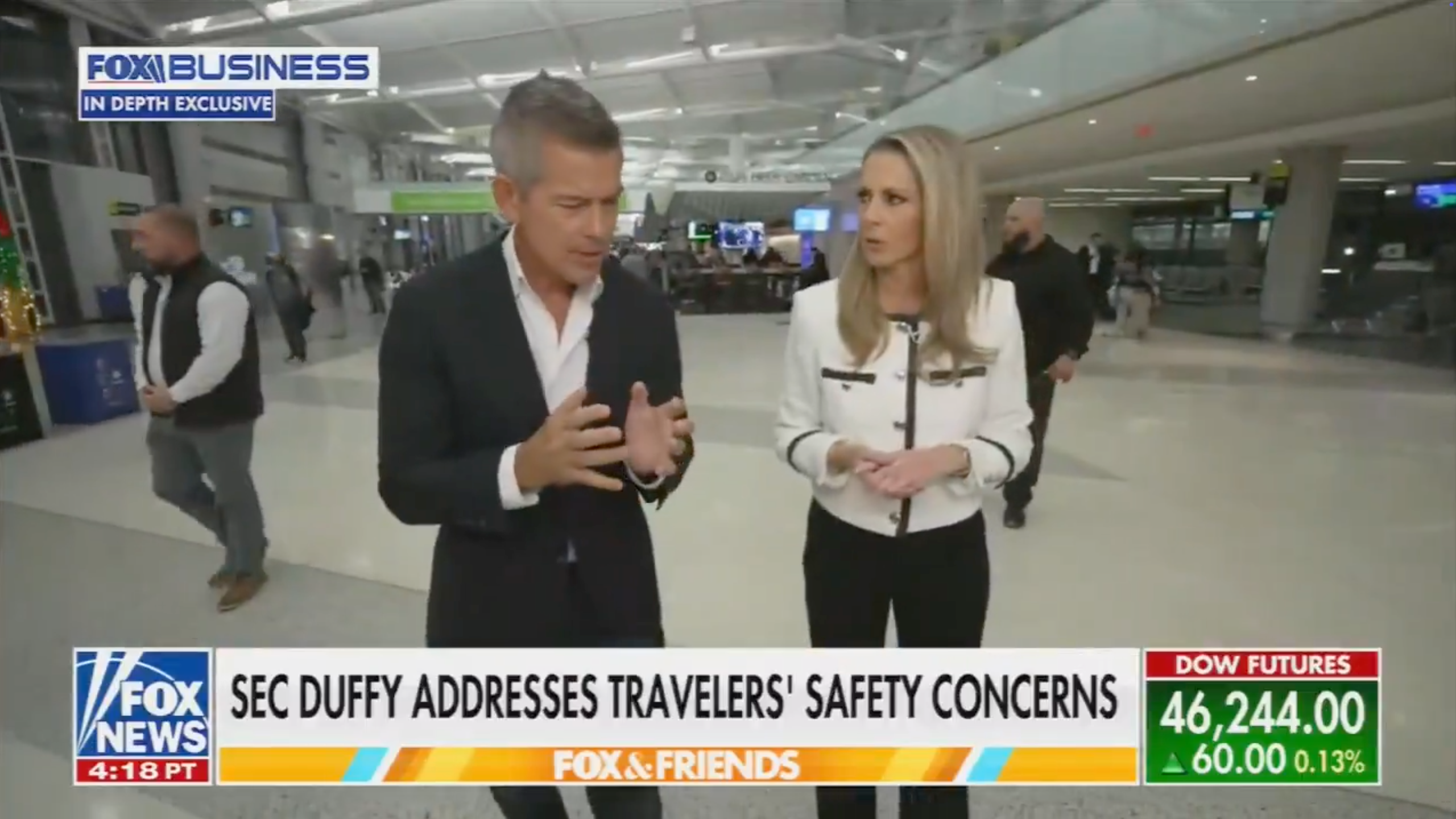 Two individuals are walking successful  an airdrome  setting, engaged successful  conversation. The quality    header  discusses SEC Duffy addressing travelers&#x27; information   concerns