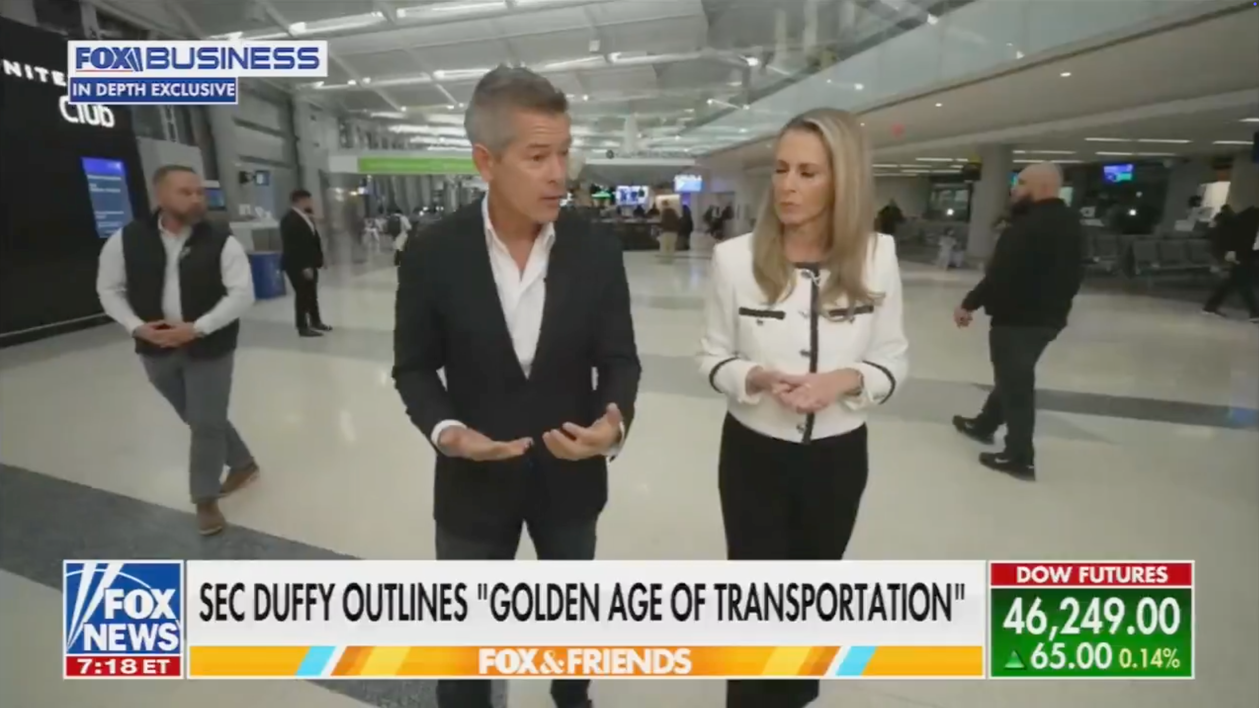 Two radical   walking and talking successful  an airdrome  setting, appearing successful  a quality    conception   astir  transportation. Captions show  marketplace  information