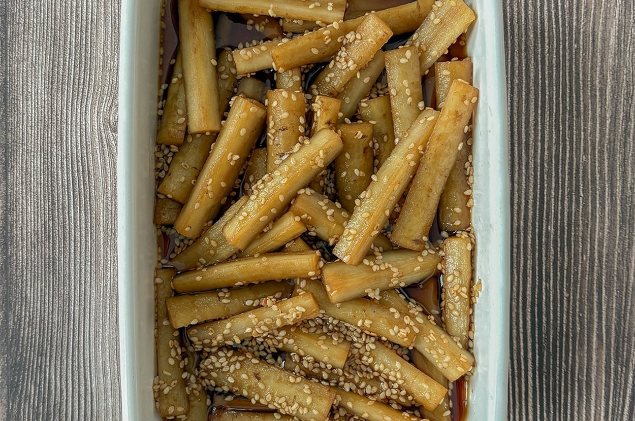 ごぼうの甘酢ごま和えが白い器に入っている。