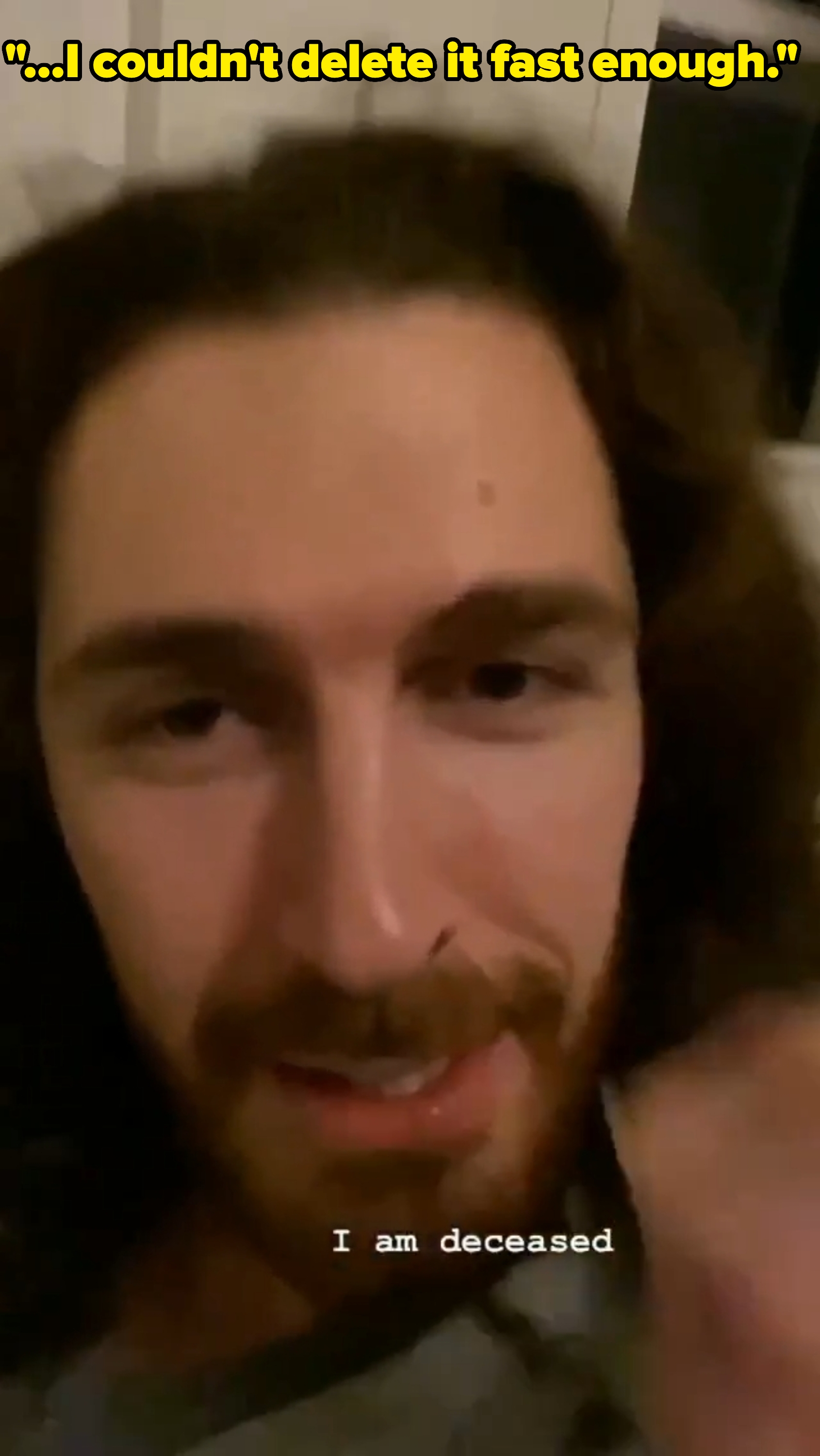 Person with long hair and beard looking at the camera, with text "I am deceased" visible at the bottom of the image