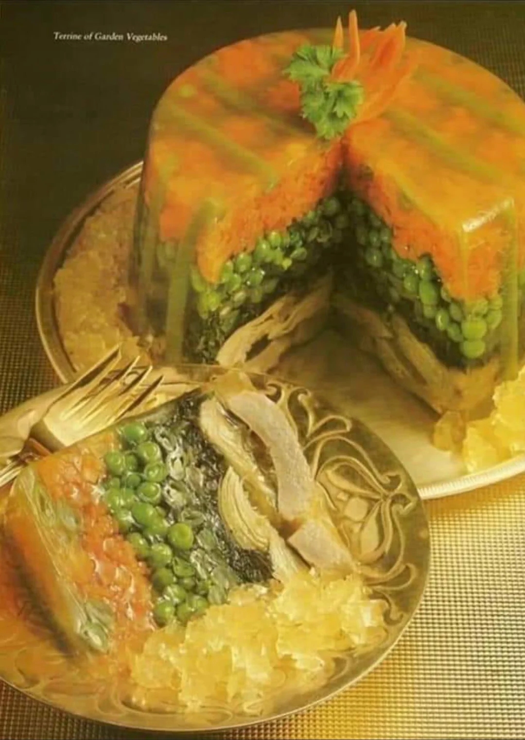 Layered vegetable terrine with peas, mushrooms, and greens in gelatin, served on a platter with a slice removed, showcasing its intricate layers