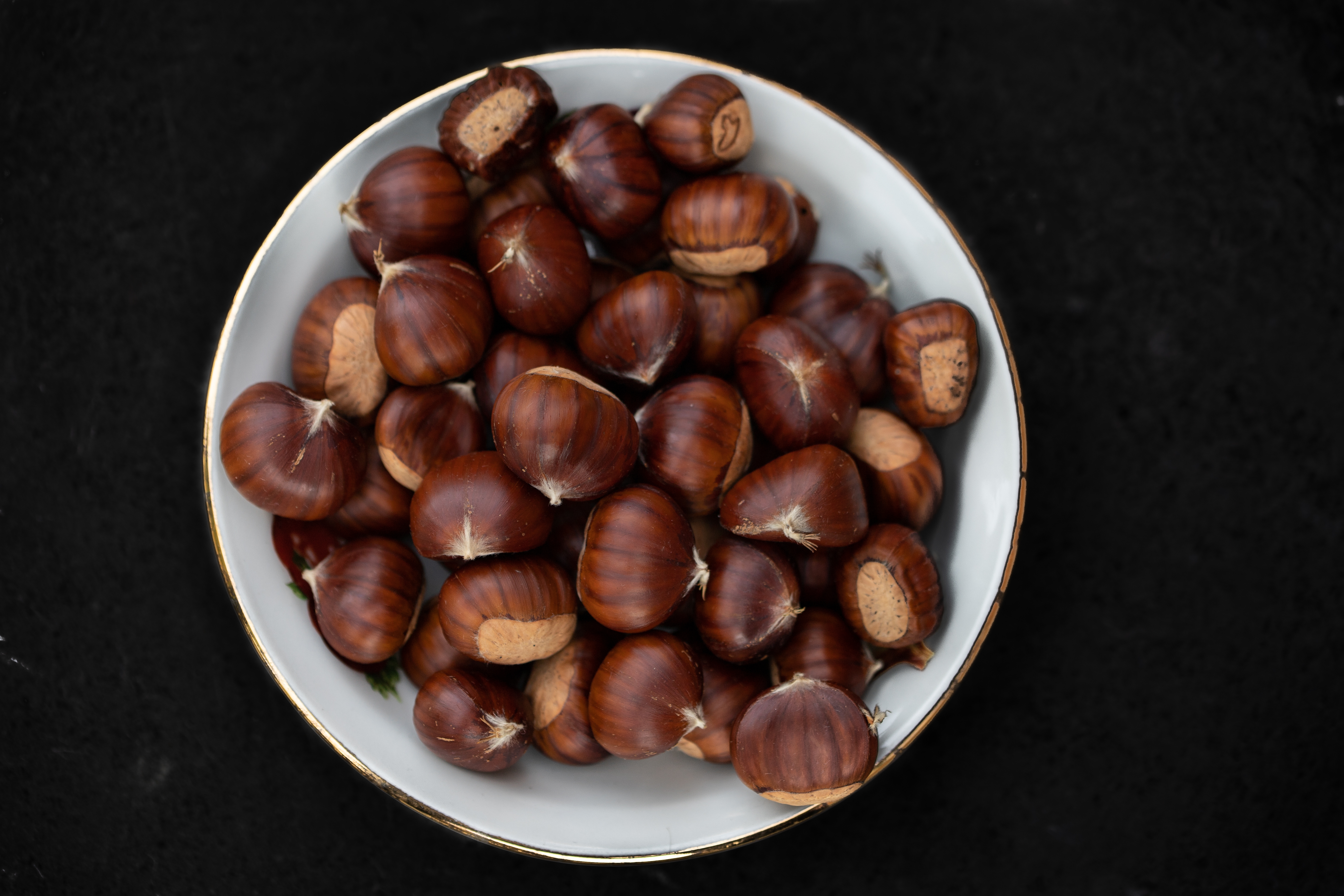 A bowl filled with raw chestnuts