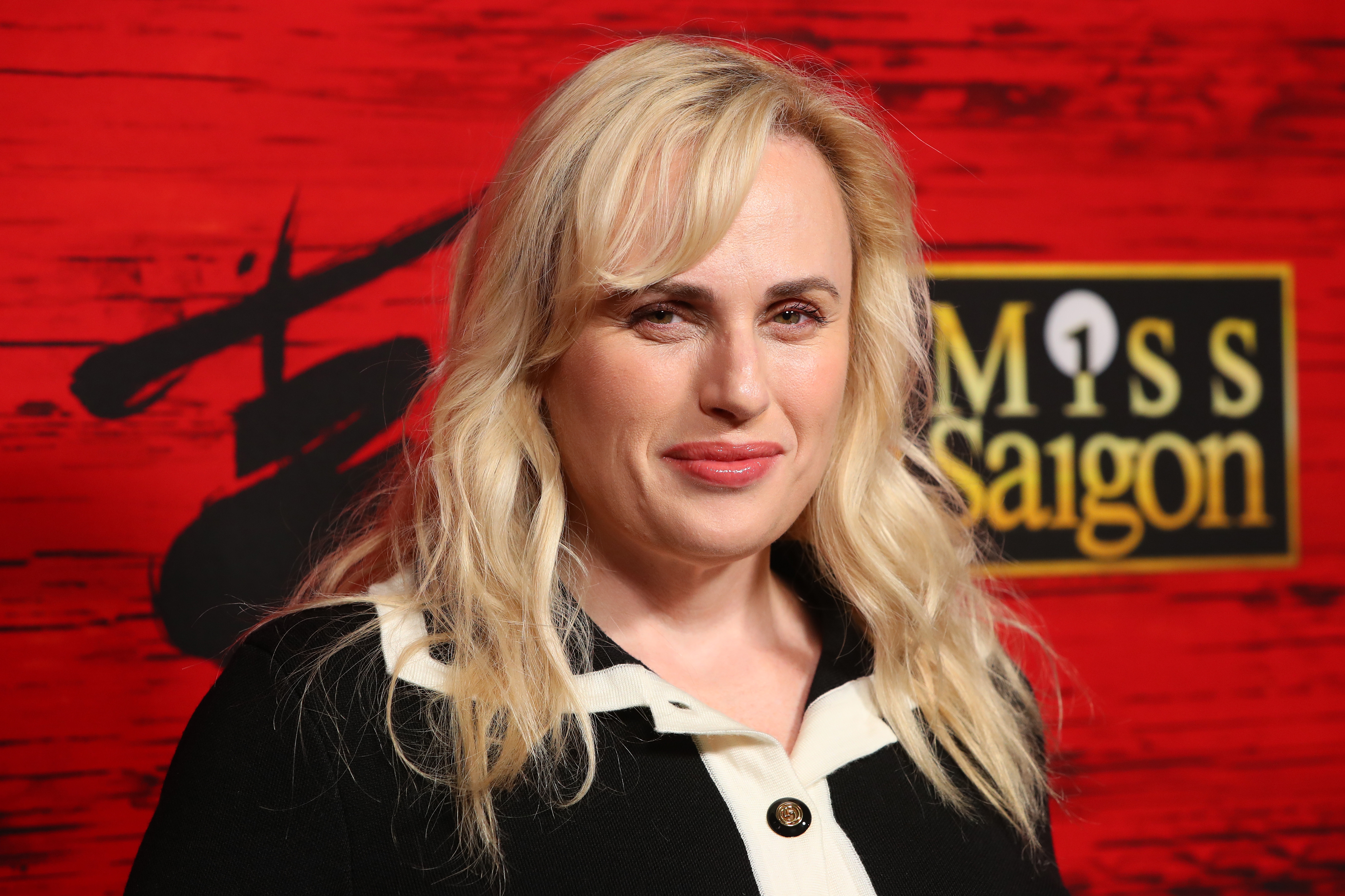 Rebel Wilson in black and white collared outfit at a "Miss Saigon" event