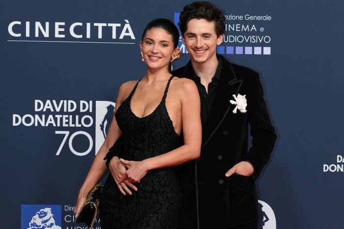 Kylie Jenner and Timothée Chalamet posing on a red carpet at an event