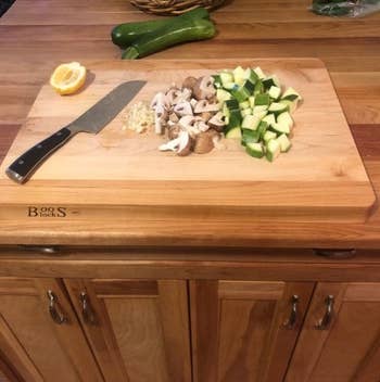 Chopped mushrooms, zucchini, and ail connected a ample woody cutting committee with a room weapon and fractional a citrus connected the side