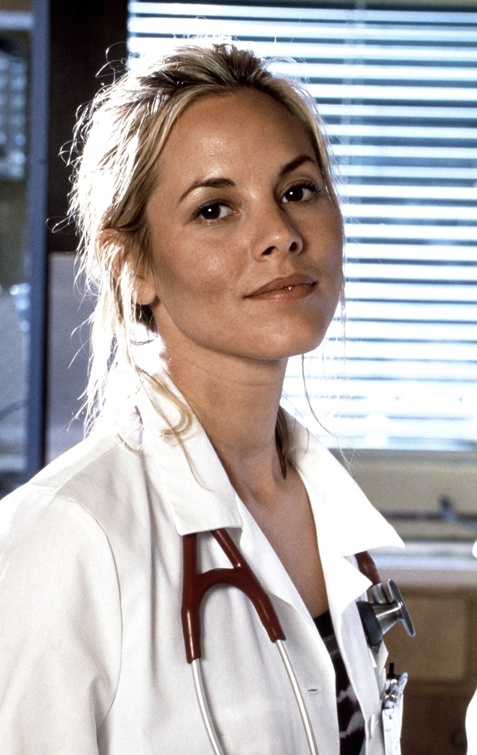 A woman wearing a white lab coat