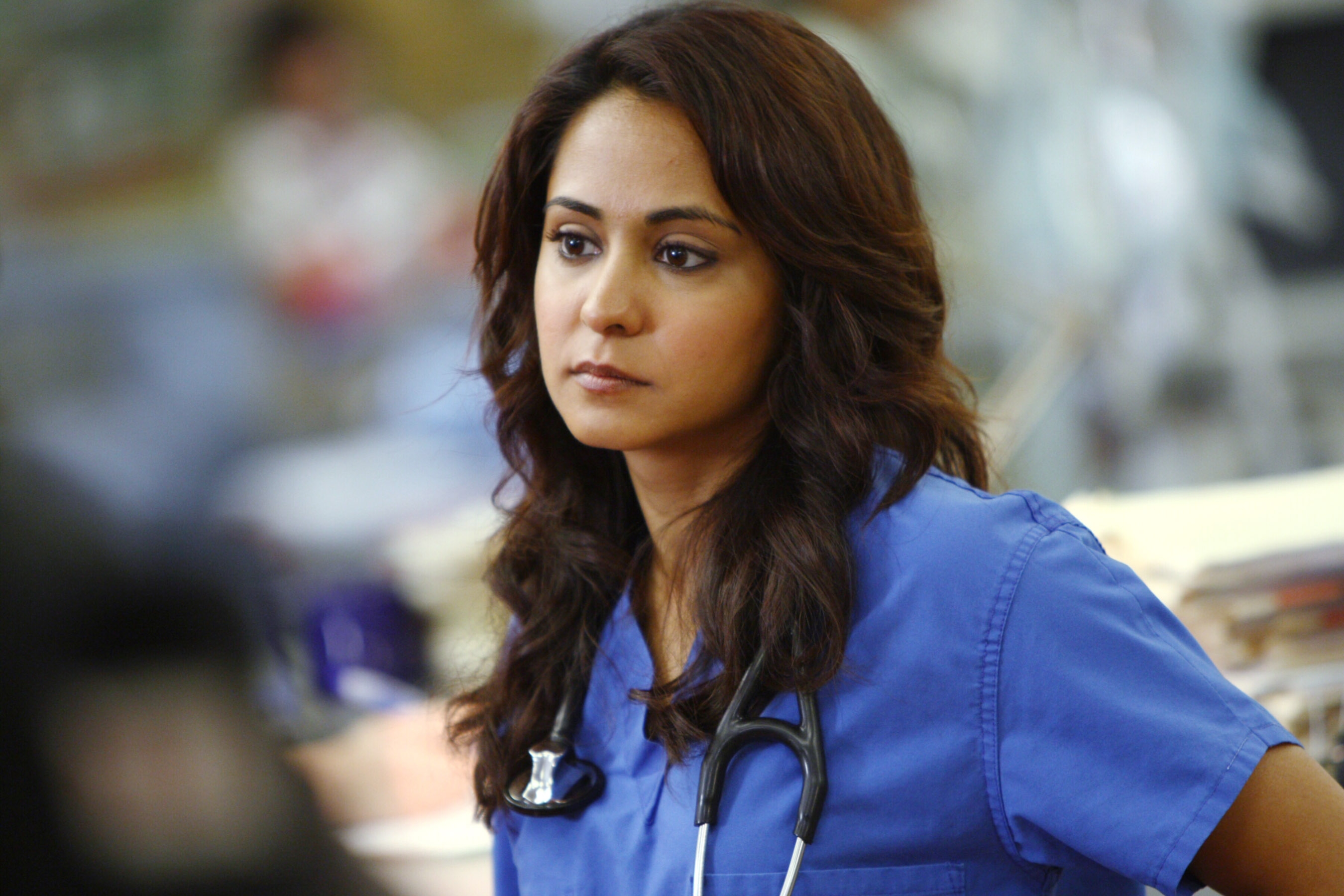A woman wearing blue scrubs