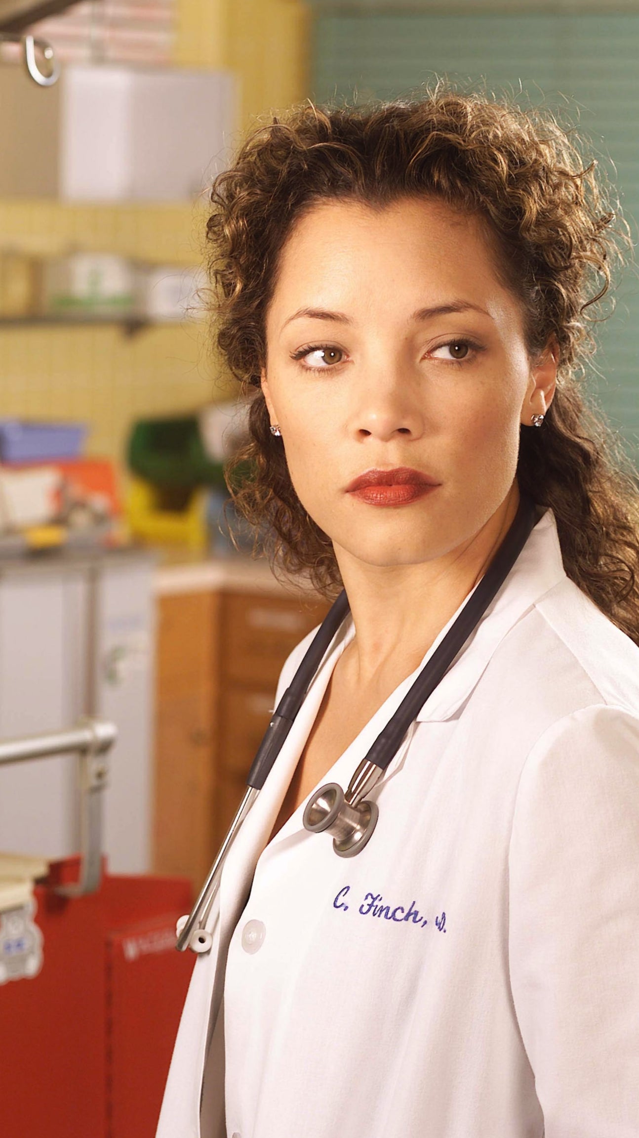A woman wearing a white lab coat