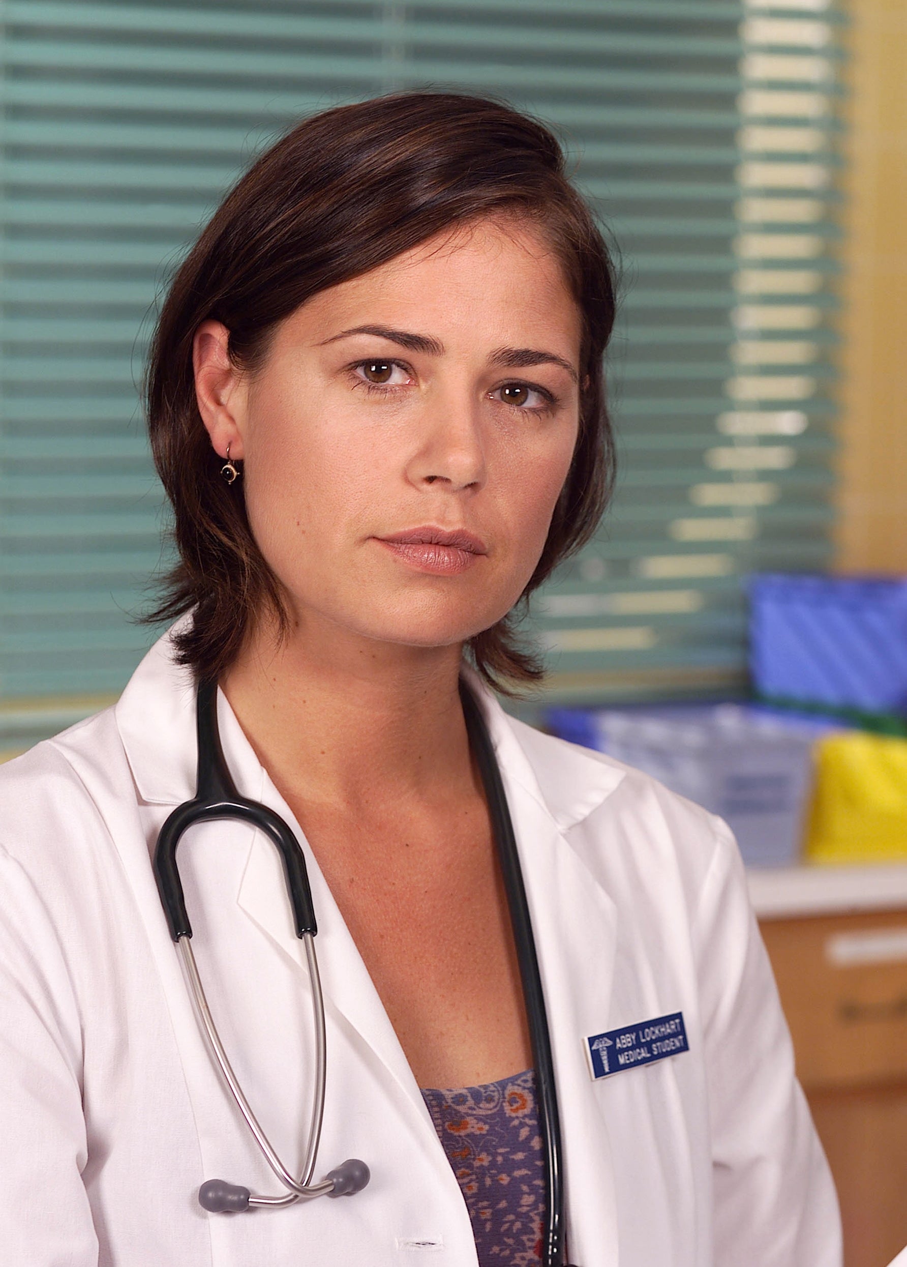 A woman wearing a white lab coat
