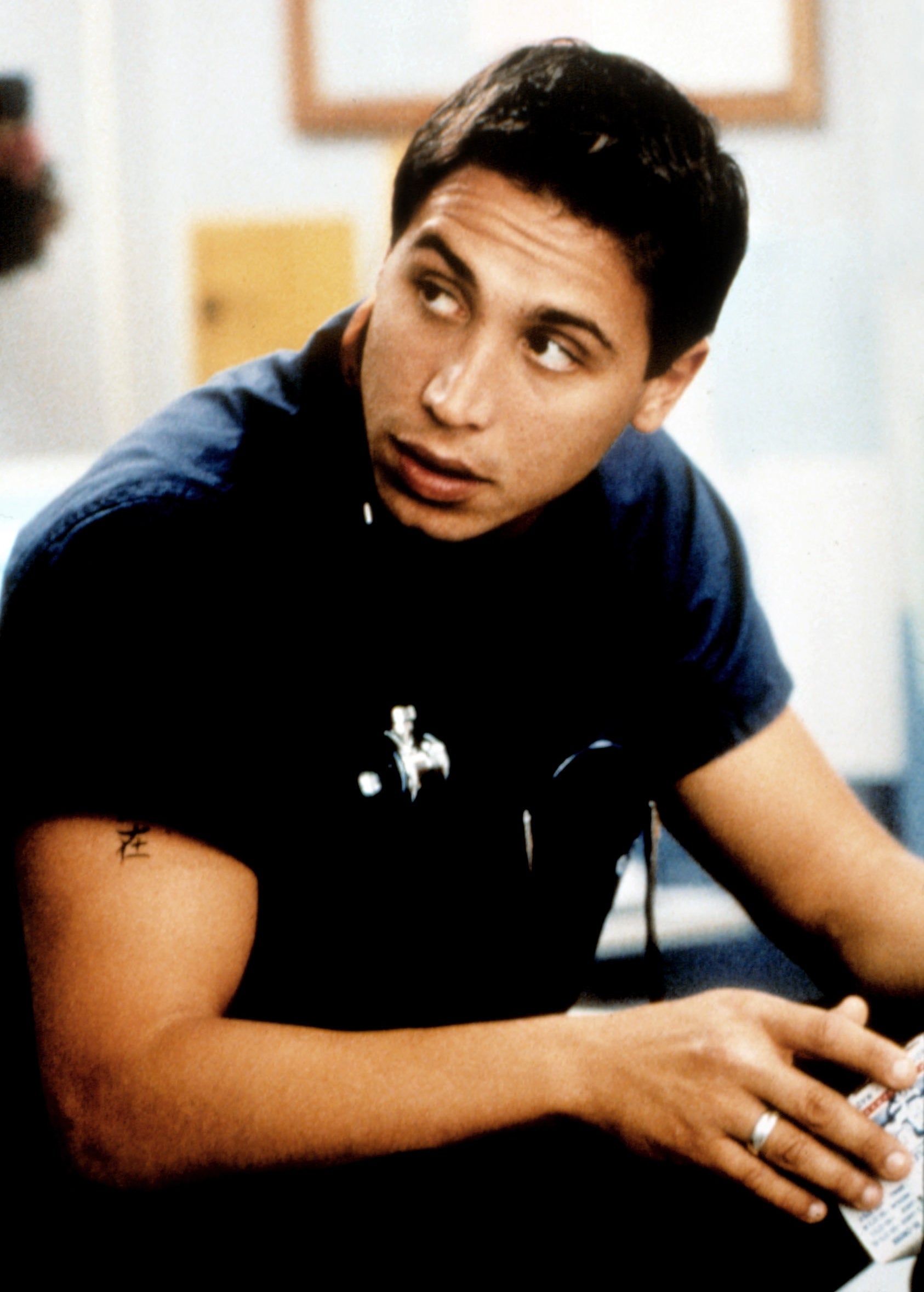 A man wearing dark blue scrubs