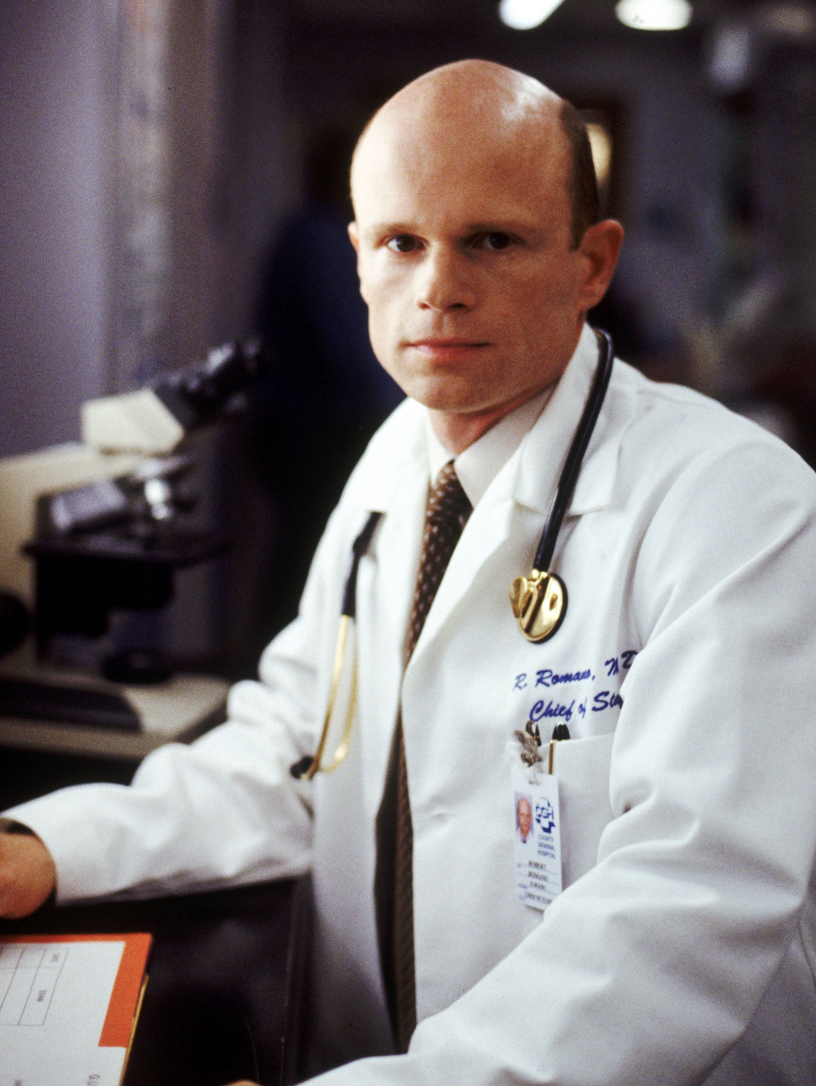 A man wearing a white lab coat