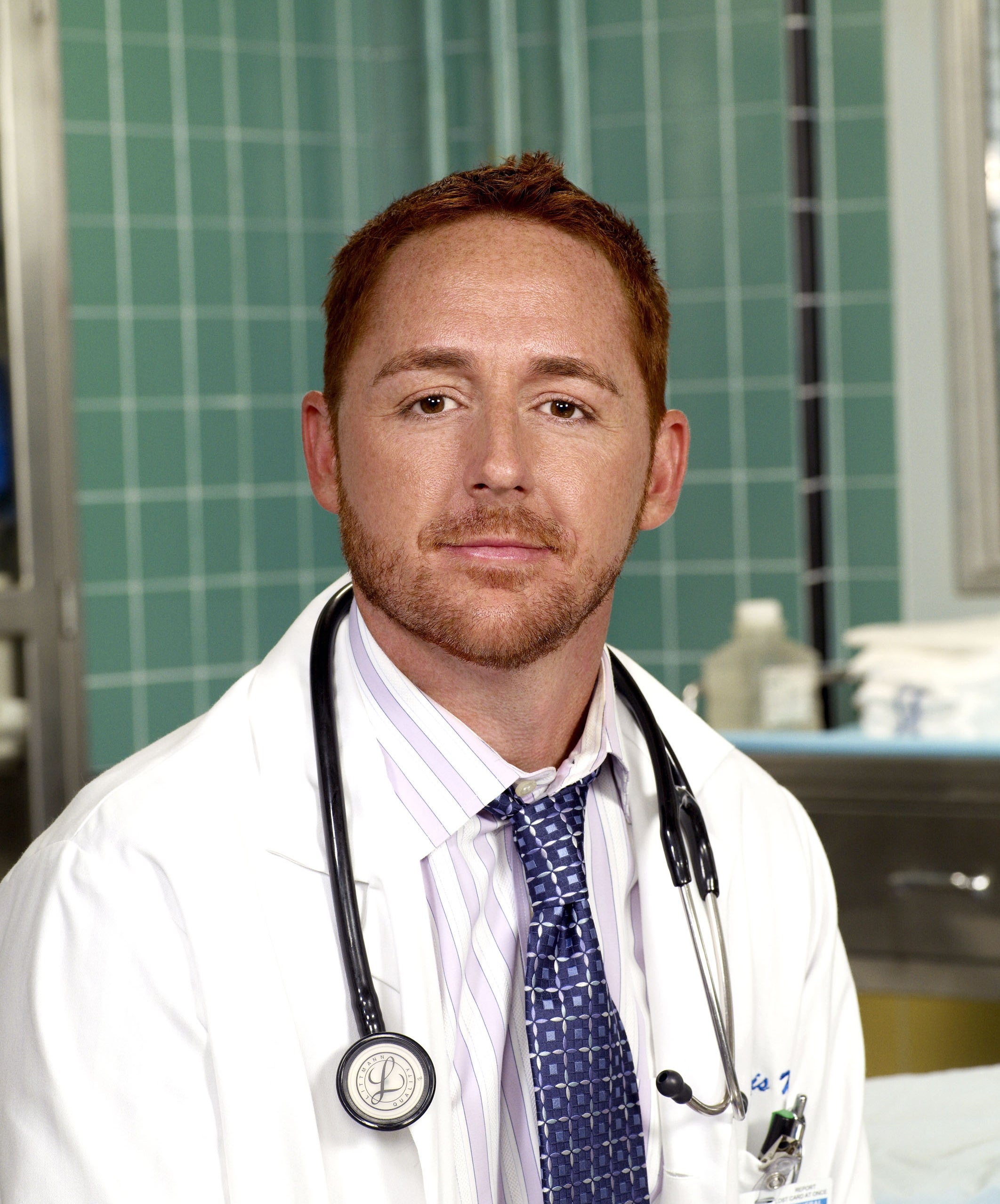 A man wearing a white lab coat and tie