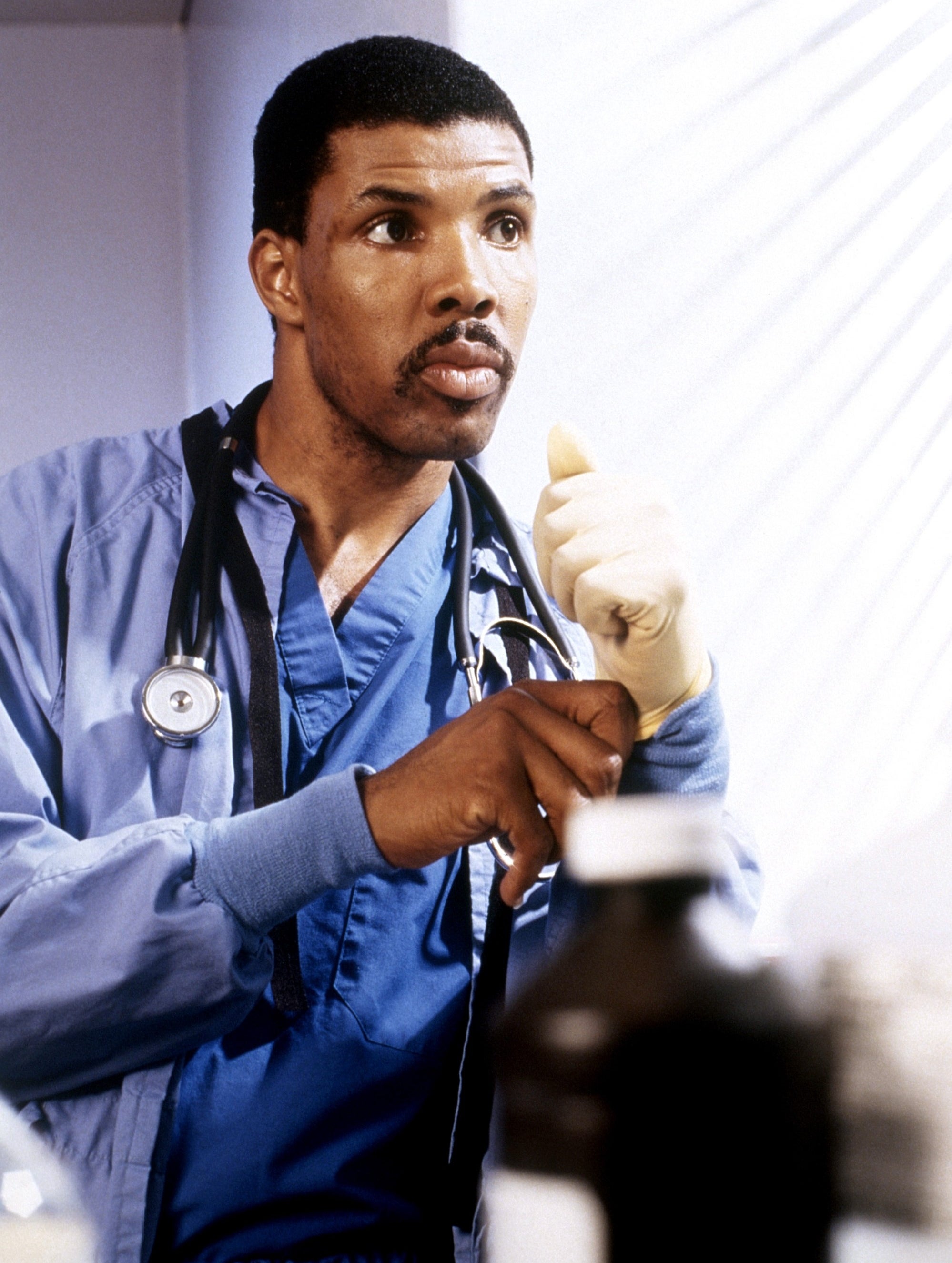 A man wearing blue scrubs