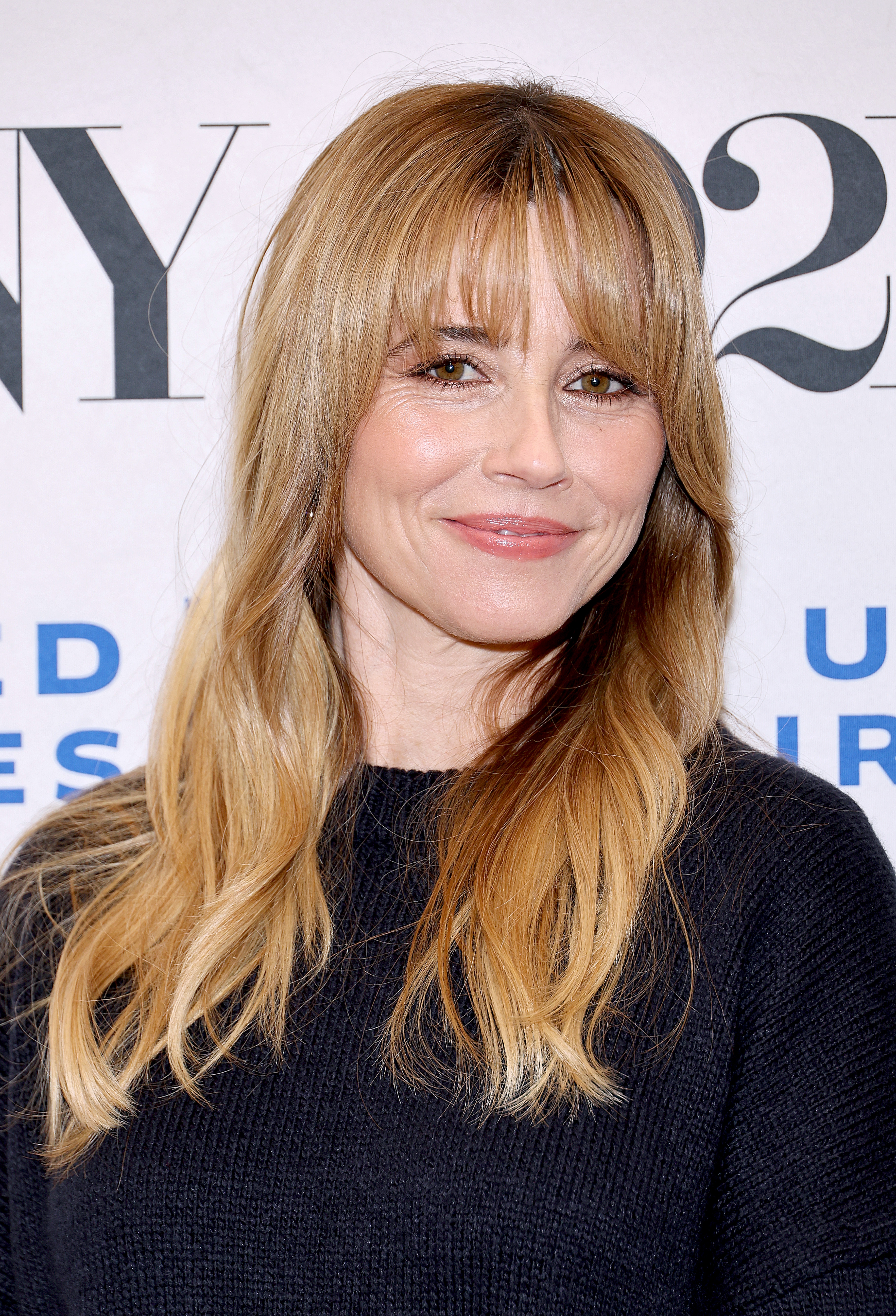 A woman wearing a black sweater