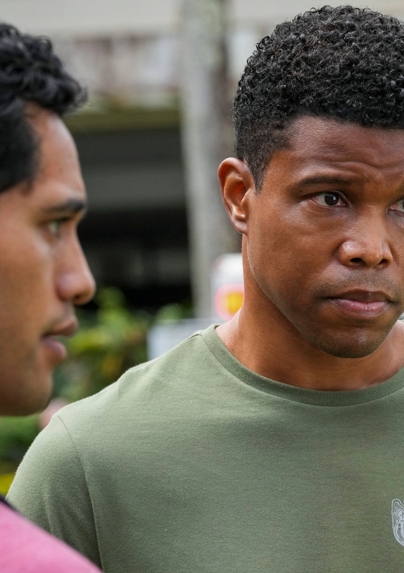 A man wearing a green t-shirt