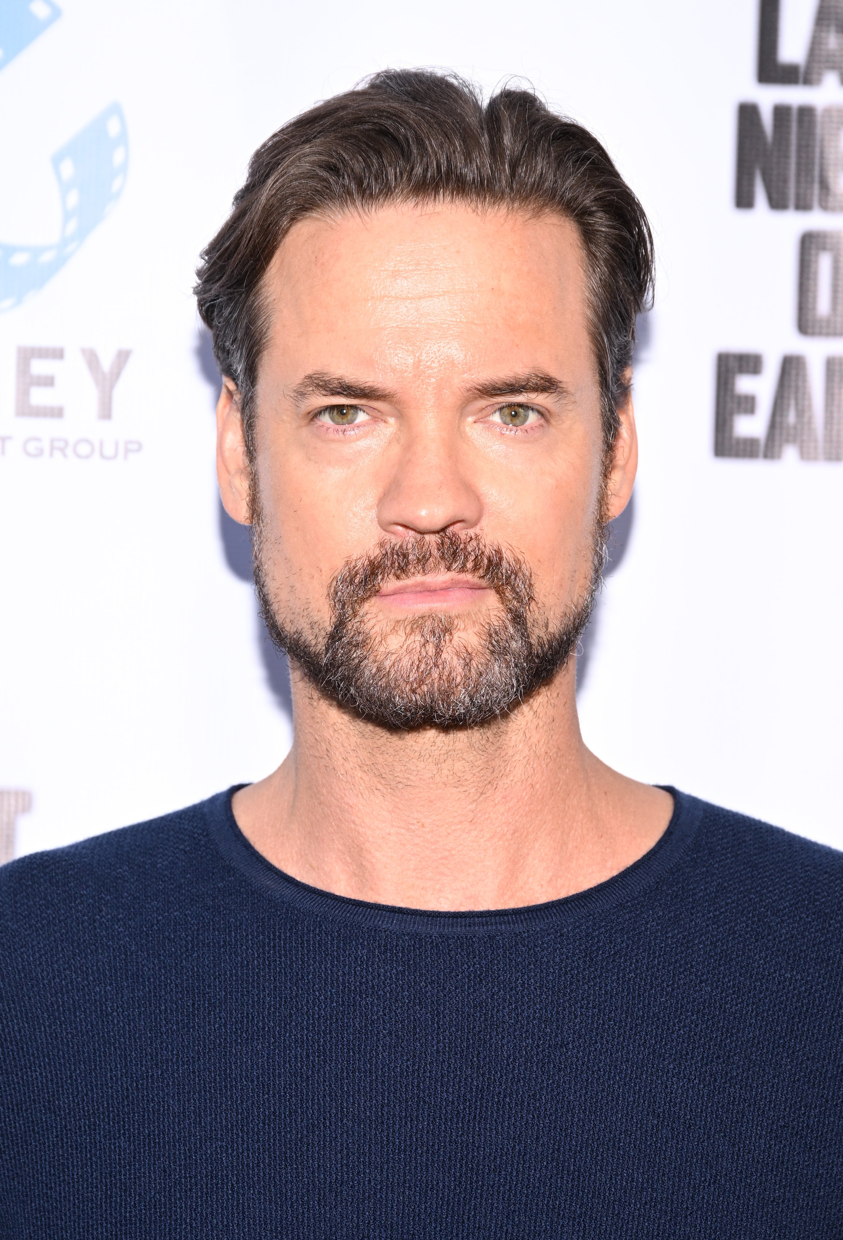 A man wearing a casual blue shirt